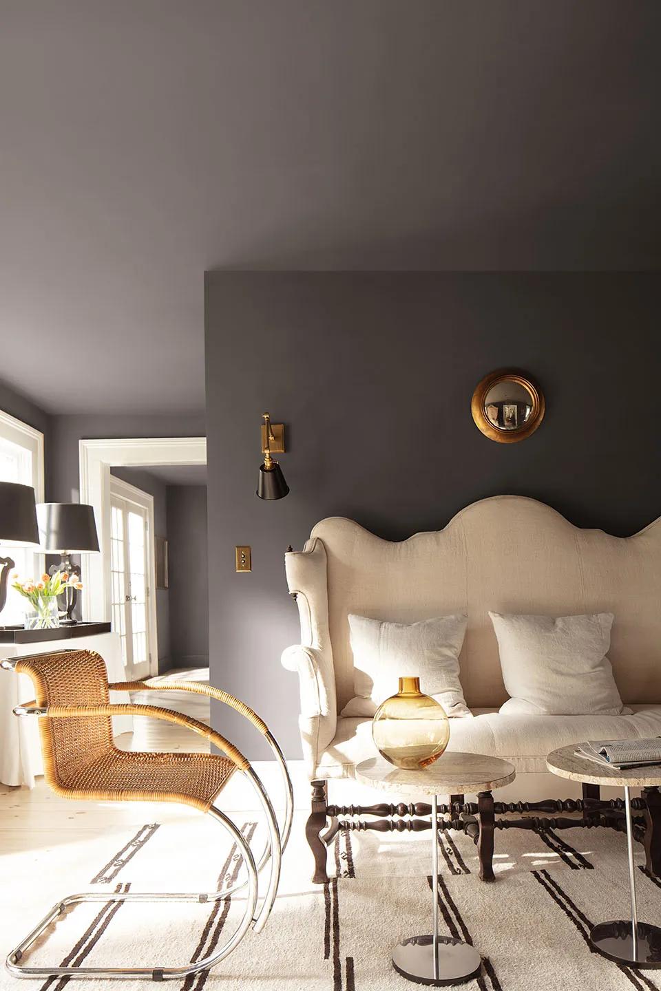 A rich chocolate brown living room painted in Silhouette AF-655